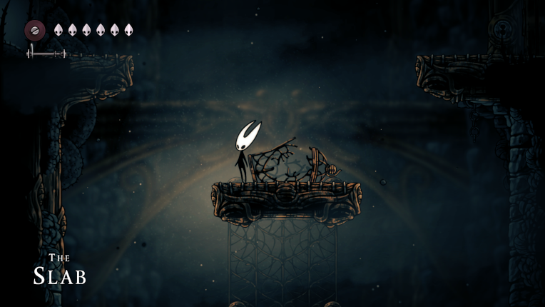 hornet, a masked bug creature, now naked, revealing a black gangly body, stands in a decrepit-looking area next to a broken cage.